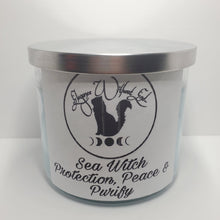 Load image into Gallery viewer, Sea Witch- Protection, Peace & Purify, Triquetra Symbol Good Intention Spell 14oz Candle with Hag Stone, Amazonite, Shungite, Abalone and Nautilus Shells